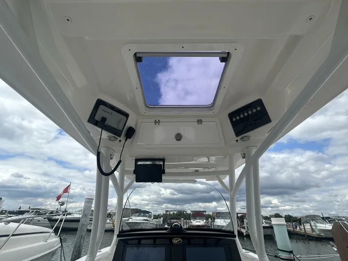  Yacht Photos Pics 2018 Sea Fox 288 Commander boat console with electronics, docked under cloudy sky.
