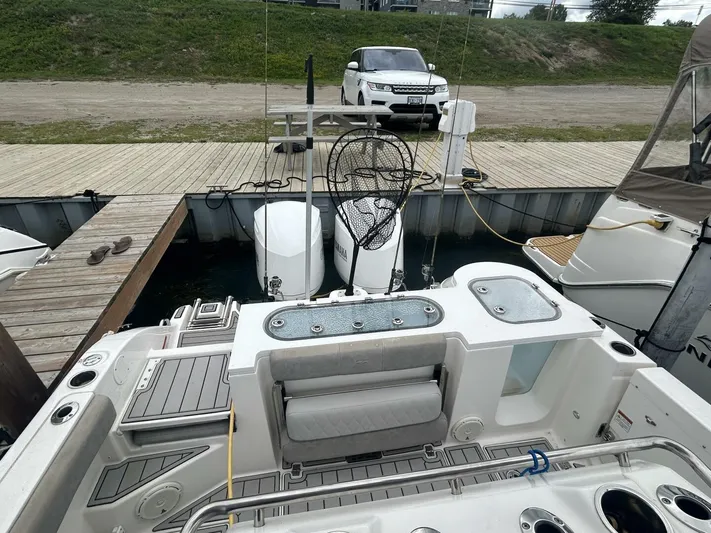  Yacht Photos Pics 2018 Sea Fox 288 Commander boat docked, featuring fishing equipment and dual outboard motors.