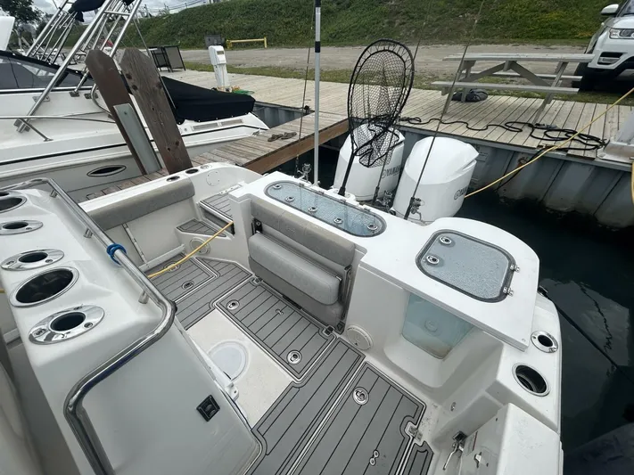  Yacht Photos Pics 2018 Sea Fox 288 Commander boat with fishing gear and dual outboard motors at dock.