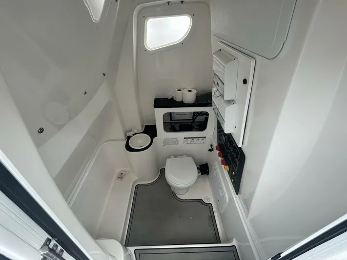  Yacht Photos Pics 2018 Sea Fox 288 Commander boat bathroom with toilet, sink, and storage compartments.
