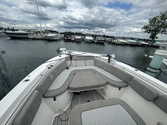  Yacht Photos Pics 2018 Sea Fox 288 Commander boat interior at marina, featuring spacious seating and calm waters.