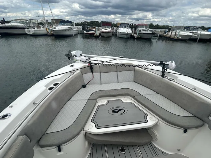  Yacht Photos Pics 2018 Sea Fox 288 Commander boat with spacious seating, docked in a marina under cloudy skies.