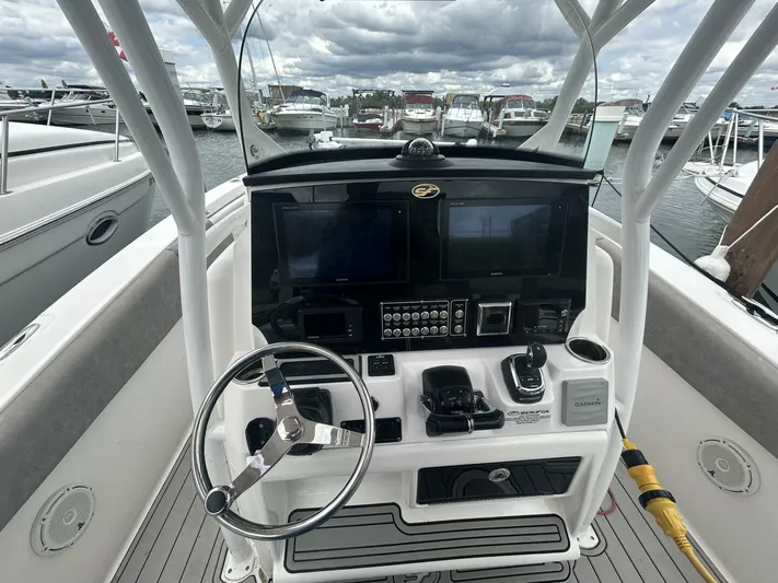  Yacht Photos Pics 2018 Sea Fox 288 Commander helm with dual displays and steering wheel, docked at marina.