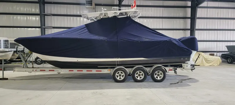  Yacht Photos Pics 2018 Sea Fox 288 Commander boat covered on a trailer in a warehouse.