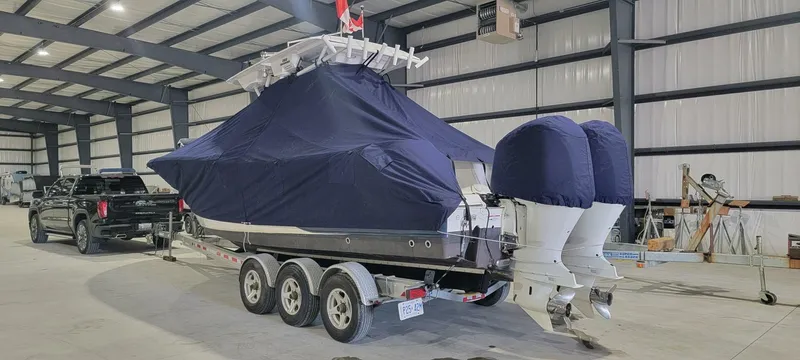  Yacht Photos Pics 2018 Sea Fox 288 Commander boat covered in a warehouse, on a triple-axle trailer.