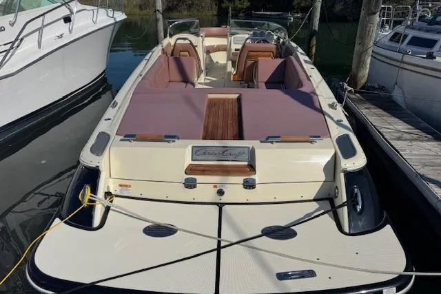 Snippy Yacht Photos Pics 2019 Chris-Craft Launch 30 boat docked, featuring elegant design and spacious seating.