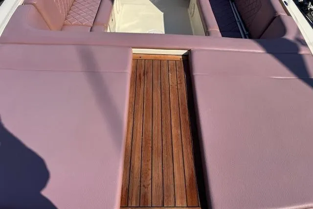 Snippy Yacht Photos Pics 2019 Chris-Craft Launch 30 boat interior with pink seating and wooden deck.
