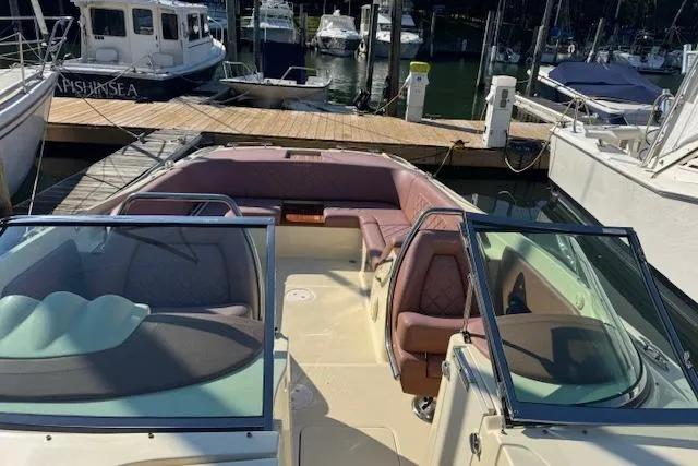 Snippy Yacht Photos Pics 2019 Chris-Craft Launch 30 boat docked at a marina, featuring spacious seating and elegant design.