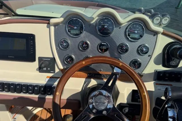 Snippy Yacht Photos Pics Dashboard of a 2019 Chris-Craft Launch 30 boat with gauges and wooden steering wheel.