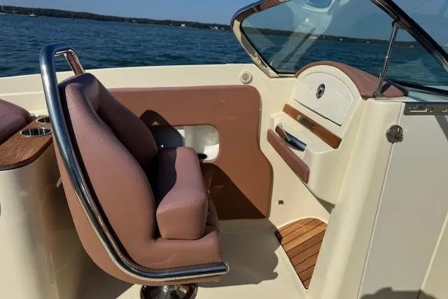 Snippy Yacht Photos Pics 2019 Chris-Craft Launch 30 interior with leather seating and wooden accents on a sunny day.