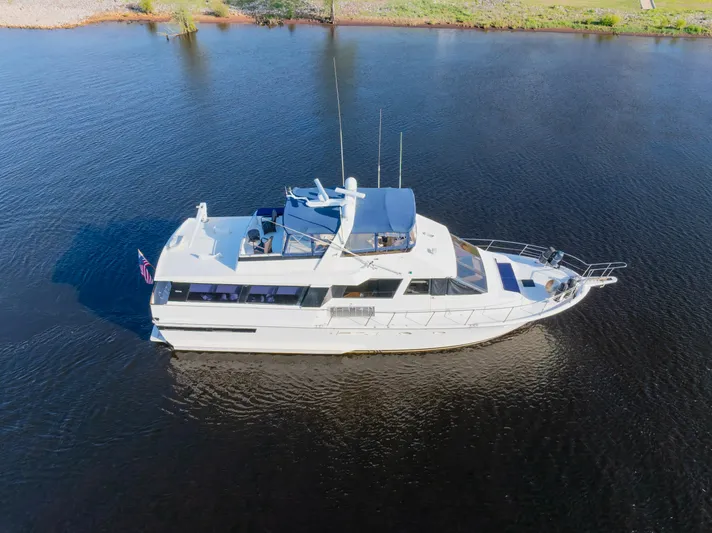 Yacht Photos Pics 1989 Viking 63 Motor Yacht cruising on calm waters, aerial view.