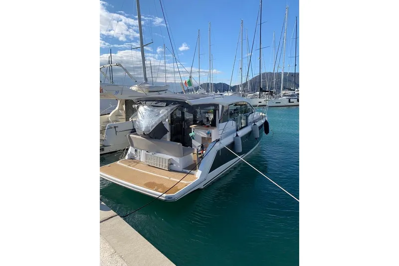  Yacht Photos Pics Sealine C330 yacht, 2016 model, docked in a marina with clear blue water.