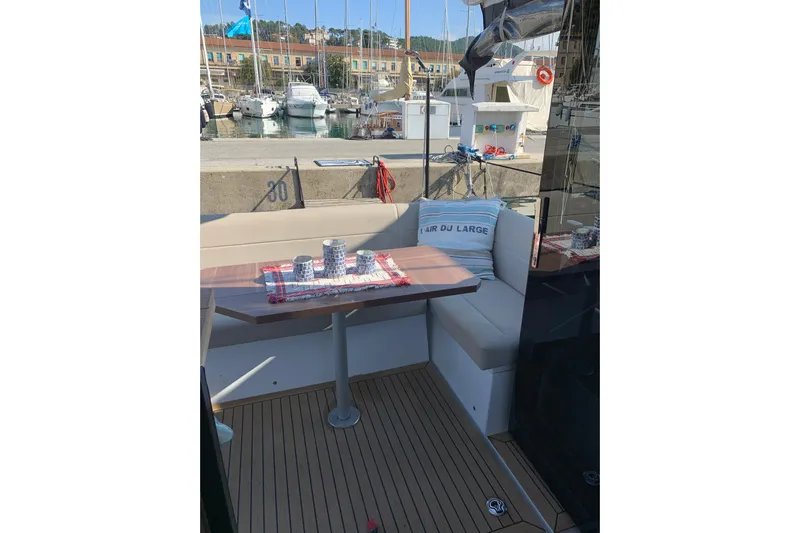  Yacht Photos Pics Sealine C330 2016 yacht interior with cozy seating and table in a marina setting.