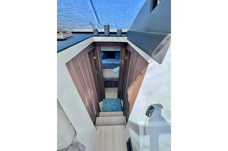  Yacht Photos Pics Interior view of 2016 Sealine C330 yacht cabin with wooden accents and blue decor.