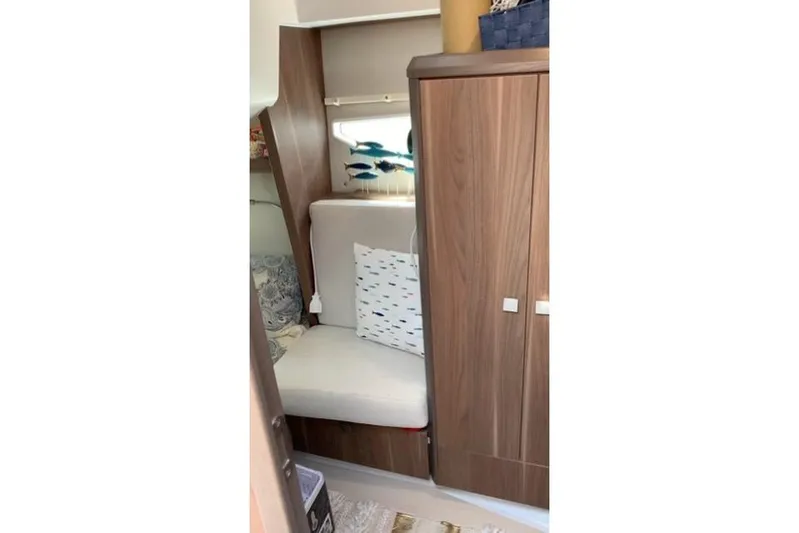  Yacht Photos Pics Cozy interior of 2016 Sealine C330 yacht with seating and wooden cabinetry.