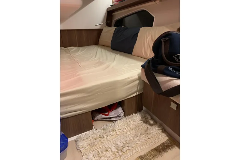  Yacht Photos Pics Cozy cabin interior of 2016 Sealine C330 yacht with bed and soft rug.