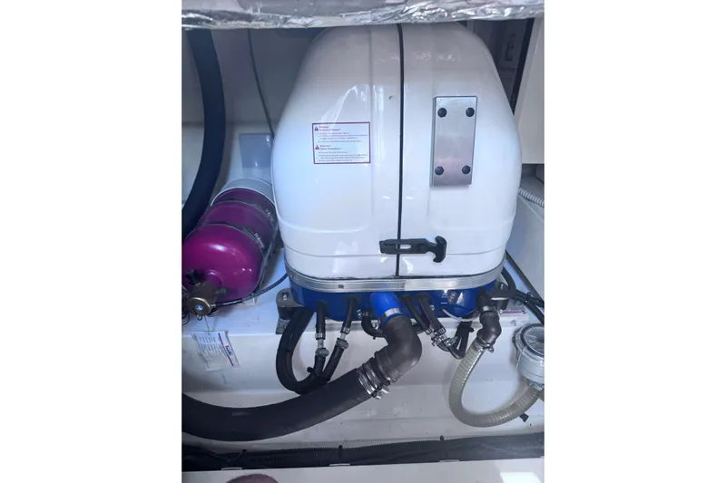  Yacht Photos Pics Engine compartment of a 2016 Sealine C330 boat with visible components and hoses.