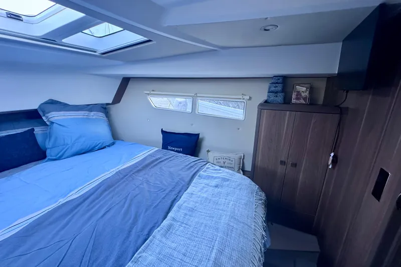  Yacht Photos Pics 2016 Sealine C330 cabin interior with bed, skylight, and wooden wardrobe.