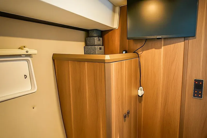  Yacht Photos Pics Interior of 2016 Sealine C330 yacht with wooden cabinetry and mounted TV.