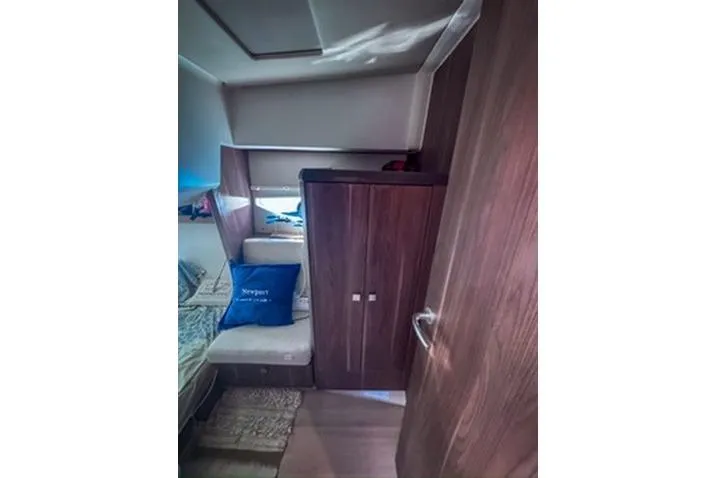  Yacht Photos Pics Interior of 2016 Sealine C330 yacht with wooden cabinetry and cozy seating area.
