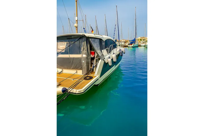  Yacht Photos Pics Sealine C330 yacht from 2016 docked in a marina, surrounded by calm blue water.