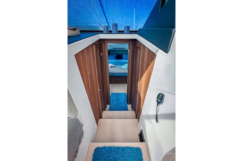  Yacht Photos Pics Interior of 2016 Sealine C330 yacht with wooden doors and blue accents.