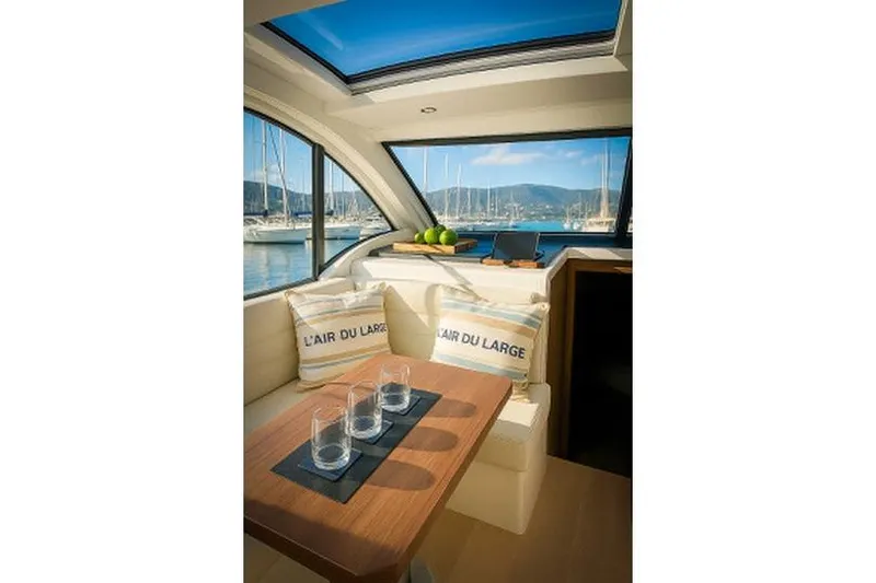  Yacht Photos Pics Interior of 2016 Sealine C330 yacht with scenic marina view through large windows.