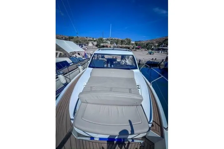  Yacht Photos Pics 2016 Sealine C330 yacht with sunbed, docked at marina under clear blue sky.