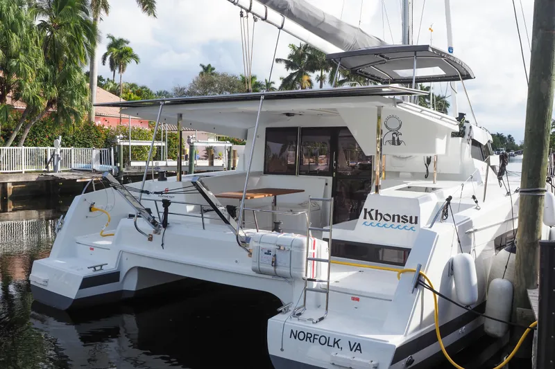 Khonsu Yacht Photos Pics 2023 Fountaine Pajot Isla catamaran docked, featuring sleek design and spacious deck.