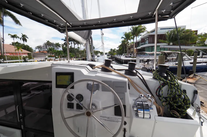 Khonsu Yacht Photos Pics 2023 Fountaine Pajot Isla yacht cockpit with steering wheel and navigation equipment.