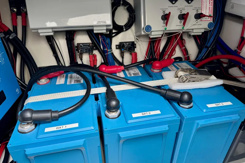 Khonsu Yacht Photos Pics Electrical system with blue batteries in a 2023 Fountaine Pajot Isla yacht.