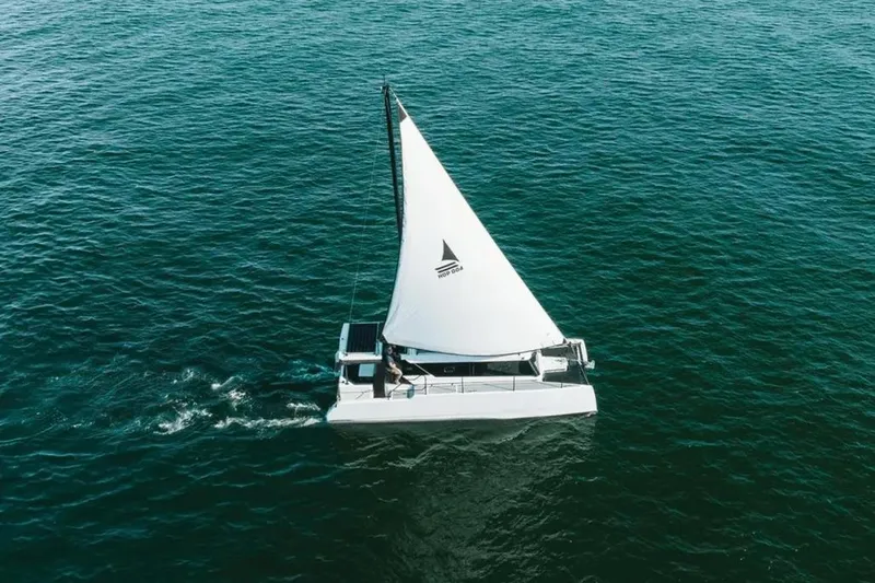 Sol Provider Yacht Photos Pics Sailing on open water, 2023 Hop Yacht 30 with white sail and sleek design.
