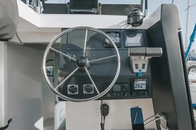 Sol Provider Yacht Photos Pics Steering wheel and controls of 2023 Hop Yacht 30, featuring modern navigation instruments.