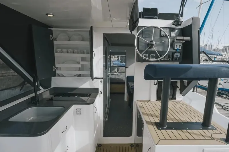 Sol Provider Yacht Photos Pics Interior of 2023 Hop Yacht 30, featuring modern kitchen and helm station.