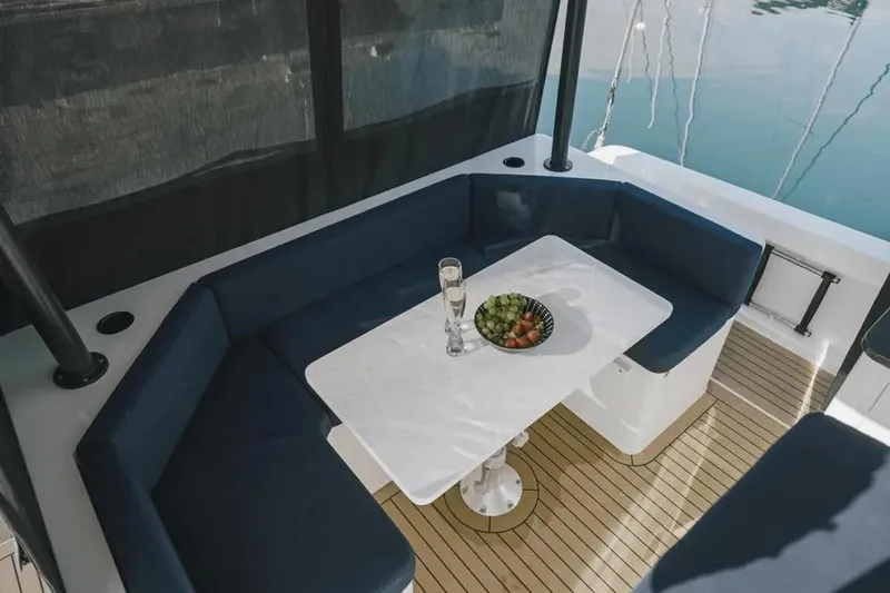 Sol Provider Yacht Photos Pics Luxurious seating area on 2023 Hop Yacht 30 with table, fruit, and drinks.