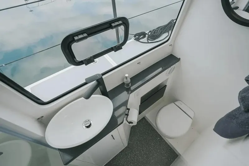 Sol Provider Yacht Photos Pics Modern bathroom interior of 2023 Hop Yacht 30, featuring sink, toilet, and window.