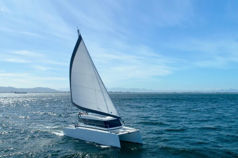 Sol Provider Yacht Photos Pics 2023 Hop Yacht 30 sailing on open sea under clear blue sky.