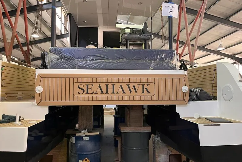 Sol Provider Yacht Photos Pics 2023 Hop Yacht 30 "Seahawk" in a warehouse, showcasing its rear design.