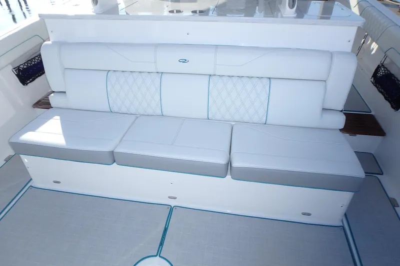  Yacht Photos Pics Luxury seating on 2022 Regal 38 SAV boat, featuring white upholstery and diamond stitching.