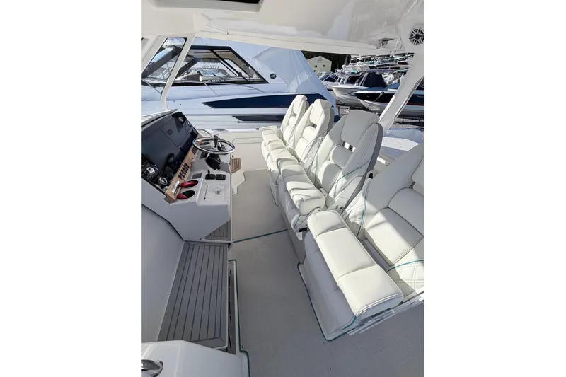  Yacht Photos Pics Interior of 2022 Regal 38 SAV boat with luxurious white seating and modern helm.