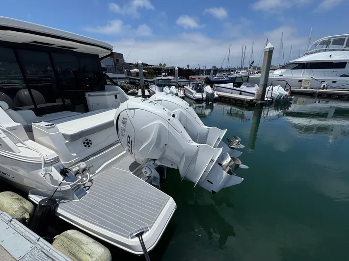 36 Xo Yacht Photos Pics 2026 Regal 36 XO boat docked with dual outboard engines in a marina.