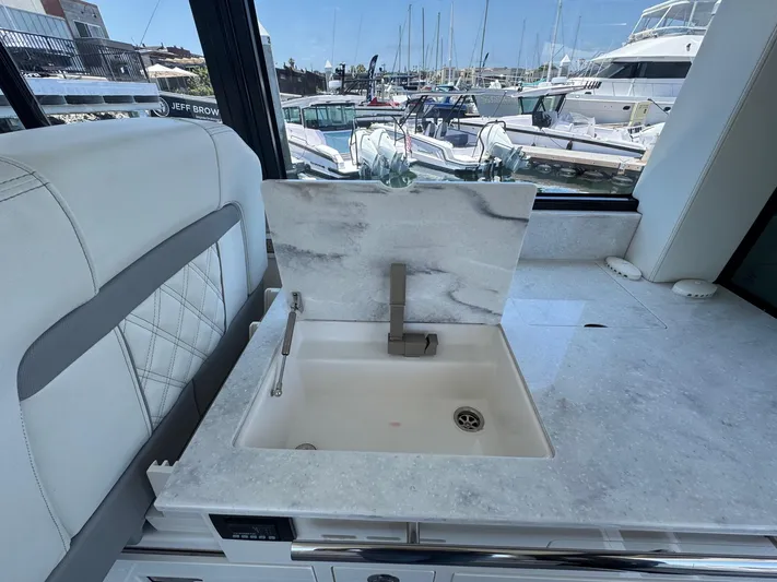 36 Xo Yacht Photos Pics Luxury yacht interior with marble sink, Regal 36 XO 2026 model, marina view in background.
