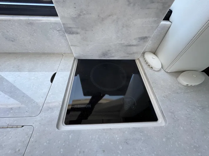 36 Xo Yacht Photos Pics Modern kitchen area on 2026 Regal 36 XO yacht with sleek induction cooktop.