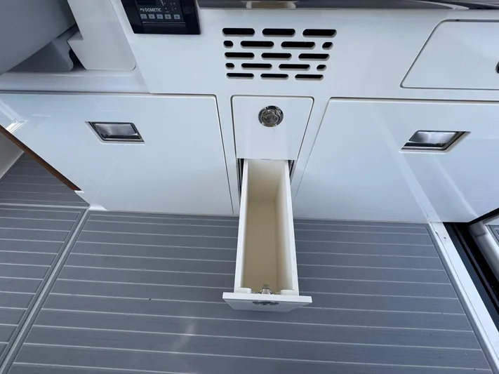 36 Xo Yacht Photos Pics 2026 Regal 36 XO boat interior with open storage drawer on sleek flooring.