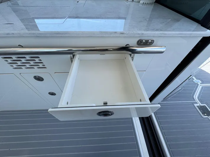 36 Xo Yacht Photos Pics Open drawer on 2026 Regal 36 XO yacht, showcasing sleek interior design.