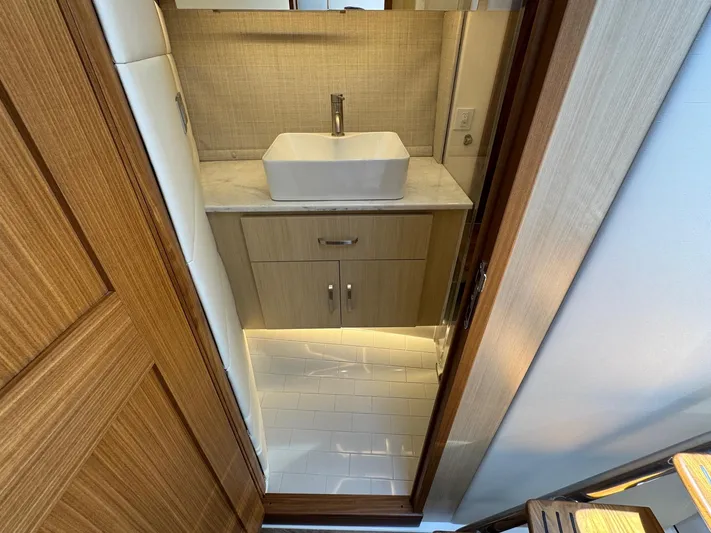 36 Xo Yacht Photos Pics Modern bathroom interior on 2026 Regal 36 XO yacht, featuring sleek sink and wooden cabinetry.