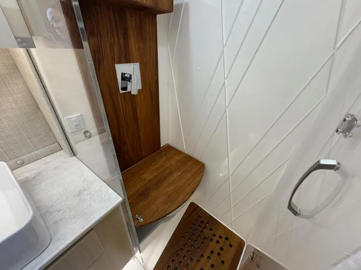 36 Xo Yacht Photos Pics Luxurious shower area in 2026 Regal 36 XO yacht with wooden seat and modern fixtures.