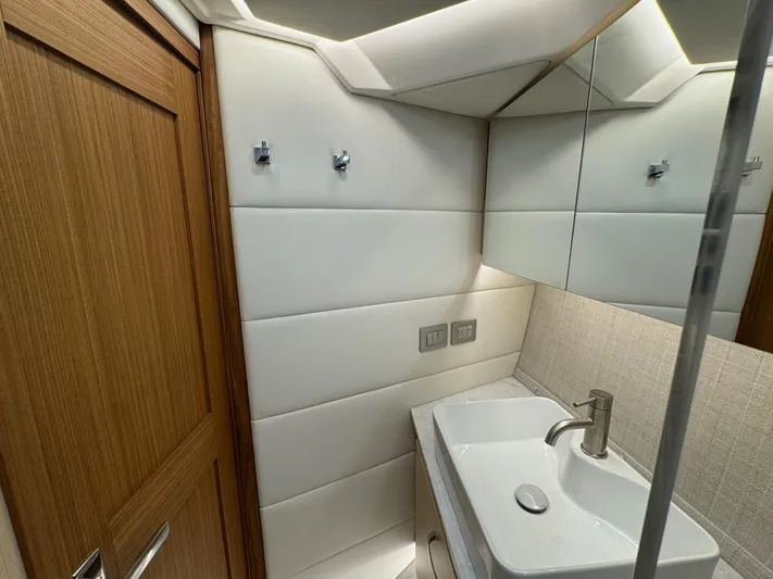 36 Xo Yacht Photos Pics Modern bathroom interior in 2026 Regal 36 XO yacht, featuring sleek sink and wooden accents.