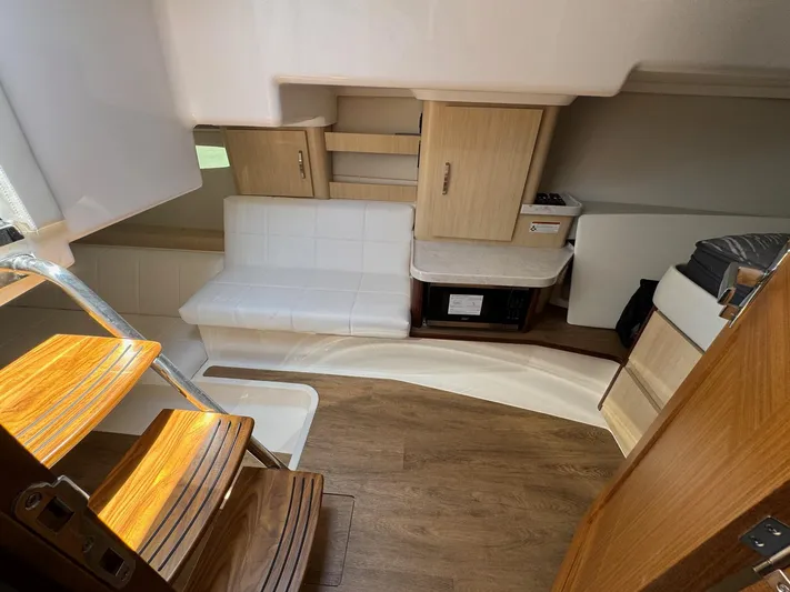 36 Xo Yacht Photos Pics Interior of 2026 Regal 36 XO yacht with wooden stairs and modern seating area.