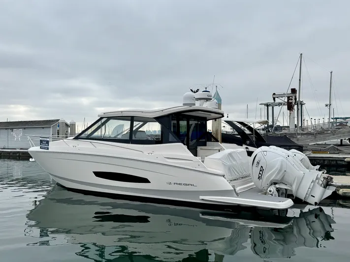 36 Xo Yacht Photos Pics 2026 Regal 36 XO boat docked at marina, featuring sleek design and twin outboard engines.